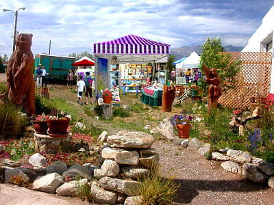 Fair tents and booths in the garden on a summer day